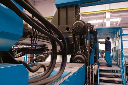 kiwa employee conducting an inspection of machinery safety in a factory