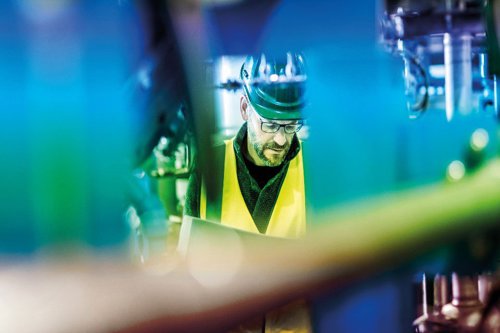 close-up of an employee in-between machines