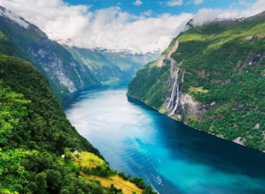 A fjord surrounded by mountains and waterfalls