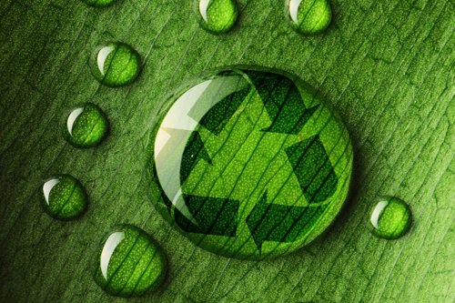 Water droplets on a green leaf, featuring a recycling symbol within one droplet, emphasizing sustainability and environmental conservation