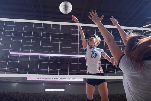 Volleyspelet i en fullsatt inomhusarena med spelare som hoppar vid nätet för att slå bollen, under en match i volleybollmästerskap, det är viktigt att kontrollera inomhusanläggningar och sportunderlag för att undvika onödiga risker för idrottare och publik.